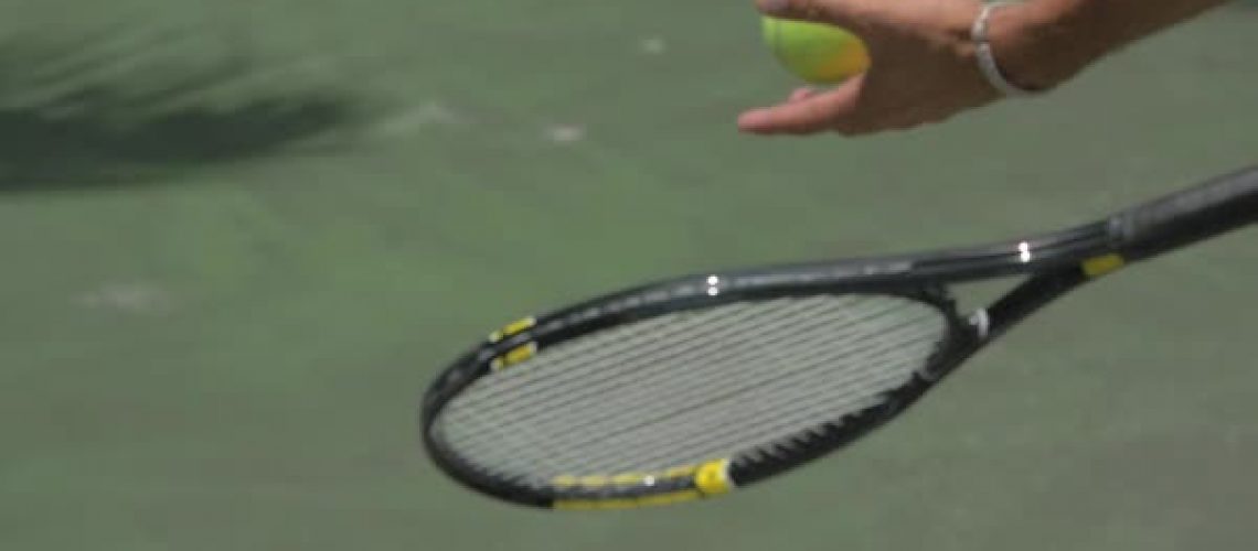 man holding racquet closeup